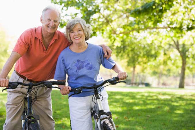senior couple cycling weight loss